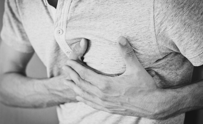 man holding on to chest